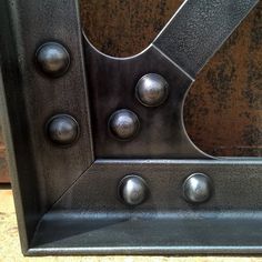 a metal door with several knobs and rivets on it