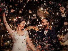 a bride and groom are surrounded by confetti