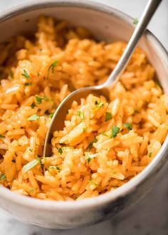 a spoon in a bowl filled with rice