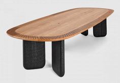 an oval wooden table with two black legs and a wood grain design on the top