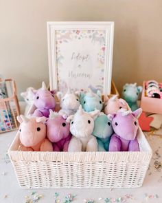 a basket filled with stuffed animals sitting on top of a table