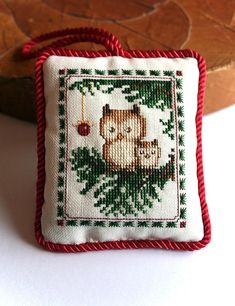 a cross stitch ornament with a bear on it