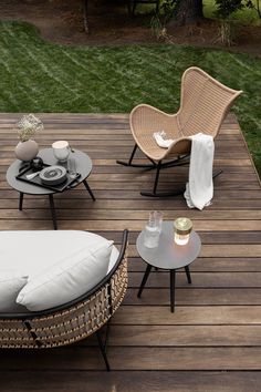 a wooden deck with chairs and tables on it