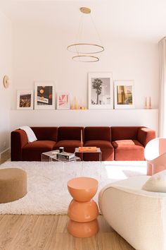 a living room filled with furniture and pictures on the wall