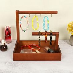 Description: [Product Name]: Solid Wood Bracelet Display Stand - This versatile storage rack is perfect for bracelets, necklaces, sweater chains, watches, rings, and more. [Material]: Made from high-quality solid wood, this display stand durable and sturdy, ensuring a long-term product life. [Size]: With dimensions of 26x18x24.5cm, this display stand provides ample space for your jewelry and accessories, keeping them organized and easily accessible. [Design]: The wood color with hanging hooks(OP Wood Bracelet Display, Stand Photography, Accessible Design, Jewelry Display Stand, Jewelry Display Stands, Bracelet Display, Wood Bracelet, Practical Storage, Earrings Women