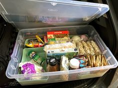 an open car trunk filled with food and snacks