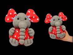 two stuffed elephants with red and white polka dots sitting next to each other on a black background