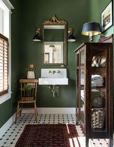 a bathroom with green walls and white flooring