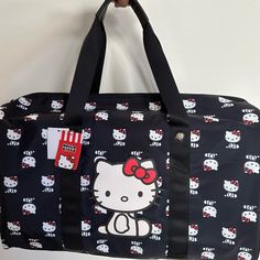 Spacious Hello Kitty Bioworld Duffel Bag Perfect To Use As A Carry On Hello Kitty Print Travel Shoulder Bag, Rectangular Hello Kitty Shoulder Bag For Travel, Travel Rectangular Bag With Hello Kitty Print, Casual Hello Kitty Print Bags For Shopping, Hello Kitty Print Shopping Bag, Rectangular, Casual Rectangular Bag With Hello Kitty Print, Casual Rectangular Bags With Hello Kitty Print, Casual Hello Kitty Everyday Bags, Hello Kitty Print Shoulder Bag For Travel