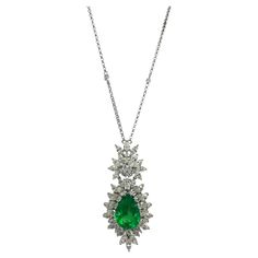 Enhance your collection with our exquisite 18k White Gold Pear Shaped Emerald and Diamond Pendant Necklace. The vibrant emerald center stone is elegantly surrounded by a dazzling array of diamond accents, creating a stunning visual impact. This luxurious piece is designed to captivate and elevate any ensemble. 18k Diamond and Pear Shaped Emerald Necklace Condition: In good condition with some minor surface wear consistent with age. Length: 16 inch chain, 1.75 inch pendant Markings: "T897” "750" Pear Shaped Diamond Necklace, Contemporary Engagement Rings, Ruby Necklace, Emerald Necklace, White Gold Necklaces, Modern Necklaces, Emerald Stone, Sapphire Necklace, Pear Diamond