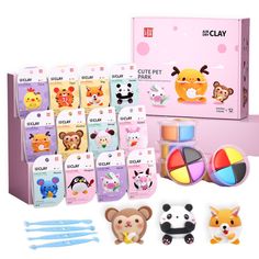 an assortment of toys and stickers in a pink box