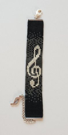 a keychain with a musical note on it and a chain attached to it