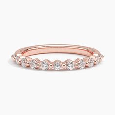 a rose gold wedding band with round diamonds