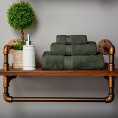 a shelf with towels and a potted plant on it