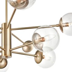 a brass chandelier with glass globes hanging from it's center point