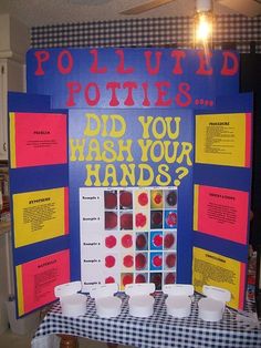 a table with some cups on it and a sign that says potluffed potatoes did you wash your hands?