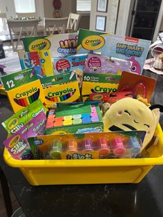 a yellow container filled with lots of crafting supplies on top of a black table