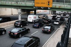 many cars are traveling down the highway with an overhead sign above them that says signal ahead