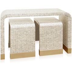 two side tables made out of wicker and gold metal bases, each with an intricate design