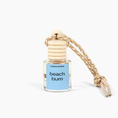 a bottle of beach bum cologne sitting on top of a rope