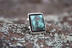 Beautiful square Nevada Turquoise stone on a silver ring. Statement piece! From the Rodgers Collection. Handmade in the USA. Size 8 Handmade Turquoise Rectangular Rings, Unique Rectangular Turquoise Ring, Handmade Square Turquoise Jewelry, Rectangular Sterling Silver Turquoise Ring As Gift, Silver Rectangular Turquoise Gemstone Ring, Rectangular Turquoise Sterling Silver Ring, Handmade Rectangular Silver Turquoise Ring, Handmade Silver Rectangular Turquoise Ring, Handmade Silver Turquoise Ring With Rectangular Shape