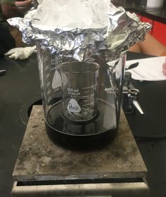 a blender sitting on top of a counter covered in aluminum foil