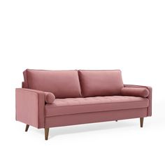 a pink couch sitting on top of a white floor