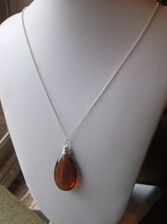 "on reserve for JA do not purchase unless you are she. I am absolutely, genuinely, unequivocally smitten over this dark amber crystal tear drop. I wrapped it in sterling silver wire to keep it pure and simple, for she is beautiful all on her own. She dances freely along 20\" of sterling silver rolo chain. Enjoy! p.s. Exciting news! This exact item went into a celebrity gift bag and was gifted to the beautiful & awesome (and my all-time favorite actress), Zooey Deschanel !! Be on the look out Elegant Brown Sterling Silver Necklace, Brown Teardrop Necklace For Gift, Brown Teardrop Necklace For Gifts, Sterling Silver Brown Necklace For Gift, Elegant Brown Jewelry Gift, Elegant Brown Jewelry For Gift, Sterling Silver Brown Wire Wrapped Jewelry, Brown Teardrop Jewelry For Gift, Everyday Brown Sterling Silver Jewelry