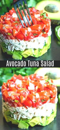 avocado tuna salad with tomatoes and cucumber on the side is being held up by a fork