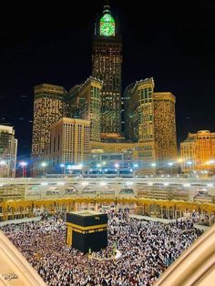 the ka'bah is surrounded by tall buildings at night