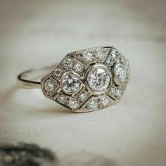 an antique diamond ring sits on a table