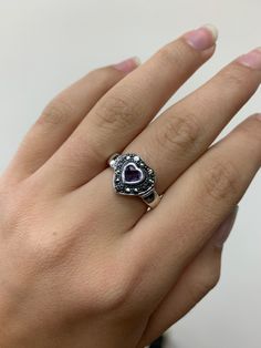 Beautiful sterling silver ring featuring a heart-shaped amethyst and sparkling marcasite accents, stamped 925. Made with ethical gemstones, this ring combines elegance with a touch of romance. Perfect for adding a unique and sophisticated charm to any outfit. Don't miss out on this exquisite piece! Ring Size: 5 3/4 U.S.  Weight: 4.0 grams  *missing a single marcasite stone Silver Sterling Silver Amethyst Ring For Valentine's Day, Valentine's Day Silver Amethyst Ring In Sterling Silver, Silver Heart-shaped Amethyst Ring For Anniversary, Silver Amethyst Heart Ring For Anniversary, Silver Heart-shaped Birthstone Ring With Gemstone, Silver Heart-shaped Amethyst Ring, Heart-shaped Silver Amethyst Ring, Marcasite Gemstone Ring For Anniversary, Amethyst Heart