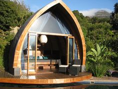 a small wooden house sitting next to a pool