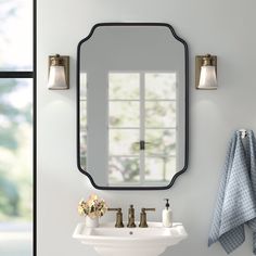 a bathroom sink sitting under a mirror next to a wall mounted faucet in front of a window