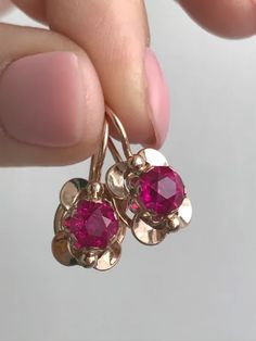 Cute and beautiful vintage «Violets» earrings with ruby corundum. Perfect gift for girl or woman.   Vintage 14K Earrings USSR 583 Rose Gold with star ruby corundum stone Soviet Retro Russian Women's jewelry 4.12 g gift for woman and girl   Base Metal: Gold 14K (Russian Hallmark: 583 Star with Sickle and Hammer)   Base Stone:  Ruby LAB (corundum)   Manufacturer Country: USSR Soviet Union Russia, Yerevan Jewelry Factory, 1980   Total weight: 4.12 g.   Enjoy your shopping! Rose Gold Ruby Earrings For Gifts, Rose Gold Ruby Round Earrings, Violet Earrings, Russian Jewelry, Faberge Jewelry, Pearl Jewelry Design, Vintage Jewelry Art, Gift For Woman, Star Ruby