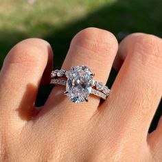 a woman's hand with a ring on it and a diamond in the middle