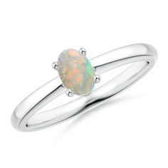 Classic and elegant, this solitaire ring brings all the attention towards the prong-set oval opal and its entrancing play of color. It is crafted in silver and features a plain shank. Classic Oval Opal Ring With Polished Finish, Oval Opal Ring With Polished Finish, Fine Jewelry Oval Opal Ring With Polished Finish, Oval Opal Ring With Polished Finish In Fine Jewelry, Classic Opal Ring With Polished Oval Cabochon, Classic Opal Ring With Oval Cabochon And Polished Finish, Oval Opal Rings With Polished Finish, Formal Oval Solitaire Opal Ring, Modern Oval Opal Ring