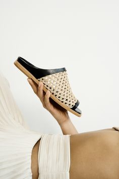 Alba Flat Slide Sandal in Black and Natural Camel Leather Woven Leather Slip-on Sandals, Leather Mules For Vacation, Chic Natural Sandals With Leather Sole, Leather Open Toe Mules With Woven Sole, Slip-on Straw Sandals With Textured Sole, Natural Open Toe Woven Leather Espadrilles, Natural Open Toe Espadrilles With Woven Leather, Natural Woven Leather Open Toe Espadrilles, Open Toe Slides With Woven Straw Sole