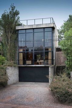 a modern house with large glass windows in the front