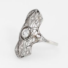 This is part of Chairish’s Fine Jewelry assortment.  Finely detailed vintage Art Deco era ring (circa 1920s to 1930s), crafted in 14 karat white gold.   Centrally mounted estimated 0.20 carat old European cut diamond is accented with 8 x estimated 0.02 carat old single cut diamonds. The total diamond weight is estimated at 0.36 carats. The centre diamond is estimated at H-I colour & SI2 clarity. The side diamonds are estimated at J-L colour and I1 clarity.   The ring features lacy filigree detai Wedding Ring Guard, Vintage Art Deco Rings, Engagement Ring Photos, Platinum Wedding Band, Art Deco Diamond Rings, Art Deco Era, European Cut Diamonds, Filigree Ring, Art Deco Ring