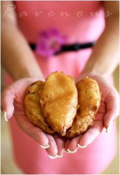 two heart shaped pastries being held in their hands