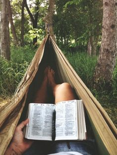 a person laying in a hammock reading a book with the words reading is my favorite escape