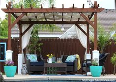 an outdoor living area with couches and tables