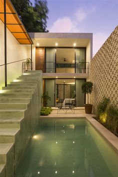 an outdoor swimming pool with steps leading up to it and a house in the background