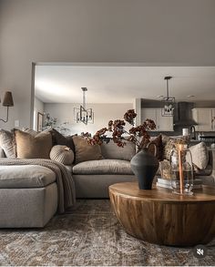 a living room filled with furniture and a large mirror