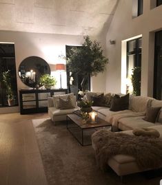 a living room filled with lots of furniture next to a fire place in a house