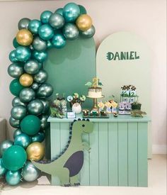 a dinosaur themed birthday party with balloons and decorations