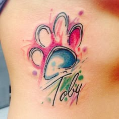 a woman with a tattoo on her stomach that has a dog's paw in it