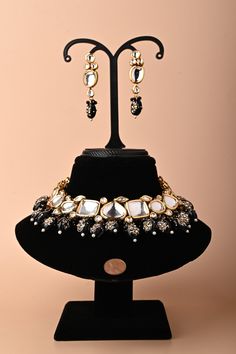 Bring your wardrobe closer to the jewelry that is carefully thought through. This is a Kundan necklace set in a collar pattern with stone work and meenakari work at the backside and matching earrings in a jharoka pattern with colorful tassels surrounding it. The penny kept beside helps to understand the real size of the ornament. Festive Designer Jhumkas With Gota Work, Festive Designer Wear Jhumkas With Gota Work, Festive Jhumkas With Gota Work, Festive Gota Work Jhumkas, Diwali Designer Jewelry With Latkans, Bollywood Style Designer Jewelry With Gota Work, Festive Designer Jewelry With Latkans, Designer Kundan Necklace With Latkans, Traditional Designer Jewelry With Zari Work