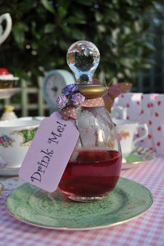 a tea pot filled with liquid sitting on top of a table